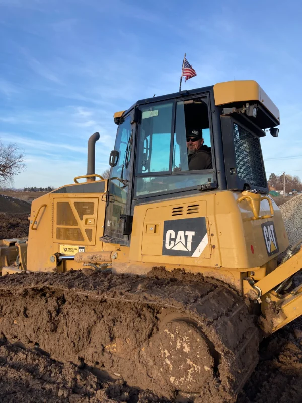 Employee smiling while working in CAT excavator