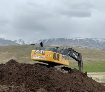 excavator on dirt mound