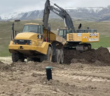 yellow excavator and truck