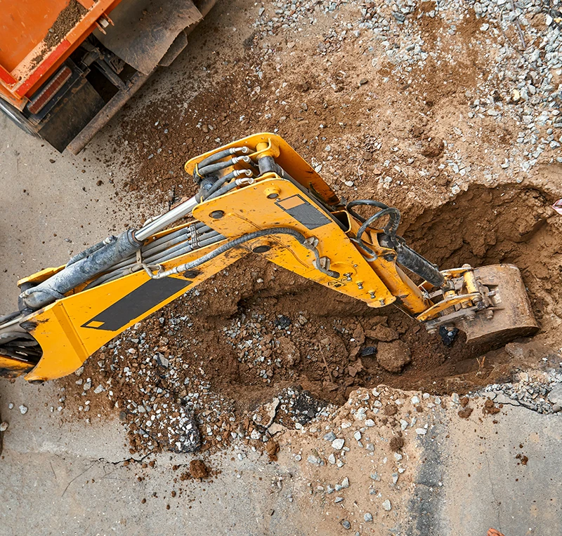 heavy equipment excavating a trench for drainage